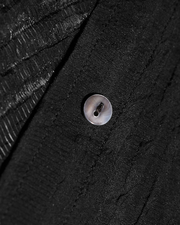 Close up of button on Seersucker Gauze Flowy Shirt - Black
