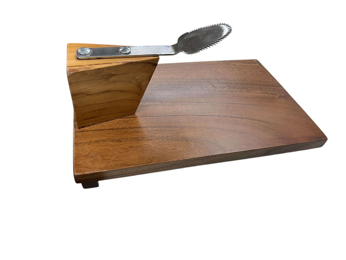 A wooden coconut scraper with a stainless steel blade mounted on a wooden base, designed to be clamped onto a tabletop.